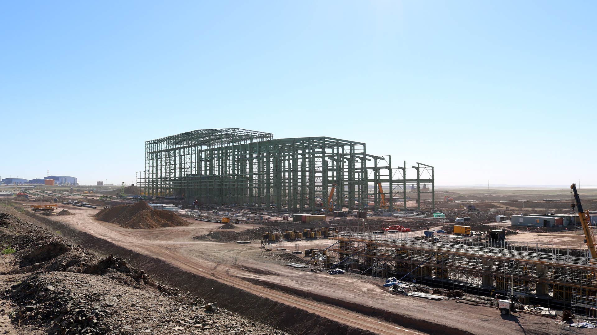 Distant view of early construction work. Large building frame of second sulphide concentrator. 