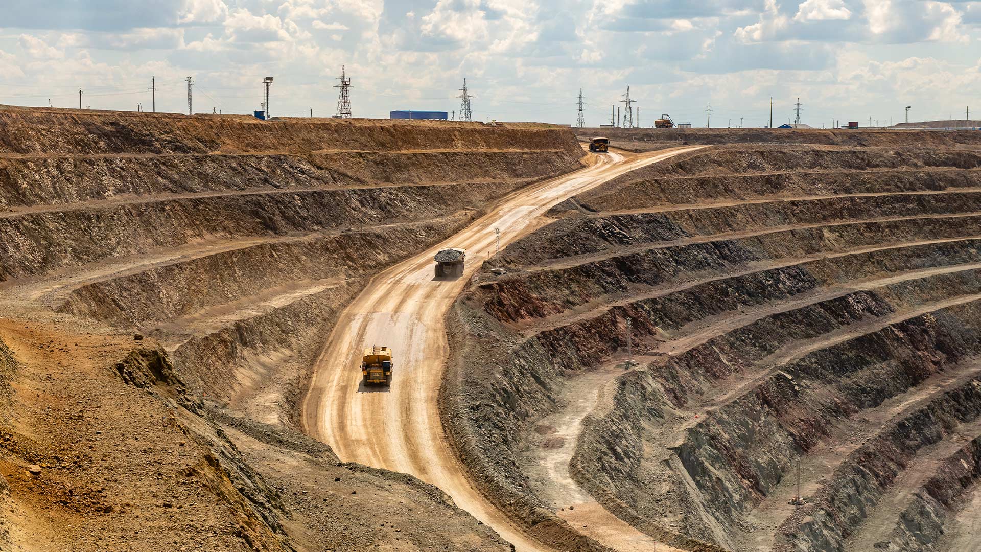 Multi-tiered outdoor natural copper mines with a road running through the centre. 