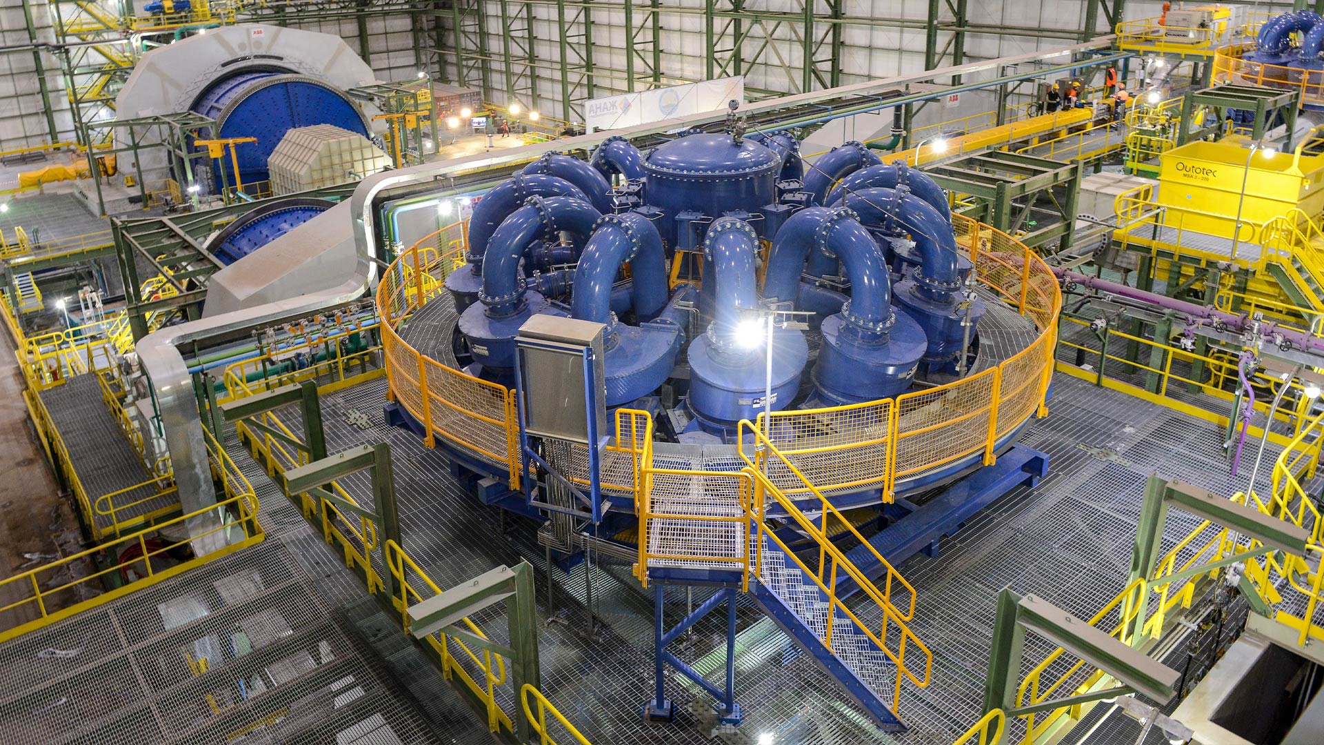 Large processing machinery set in the backdrop of large facilities. 