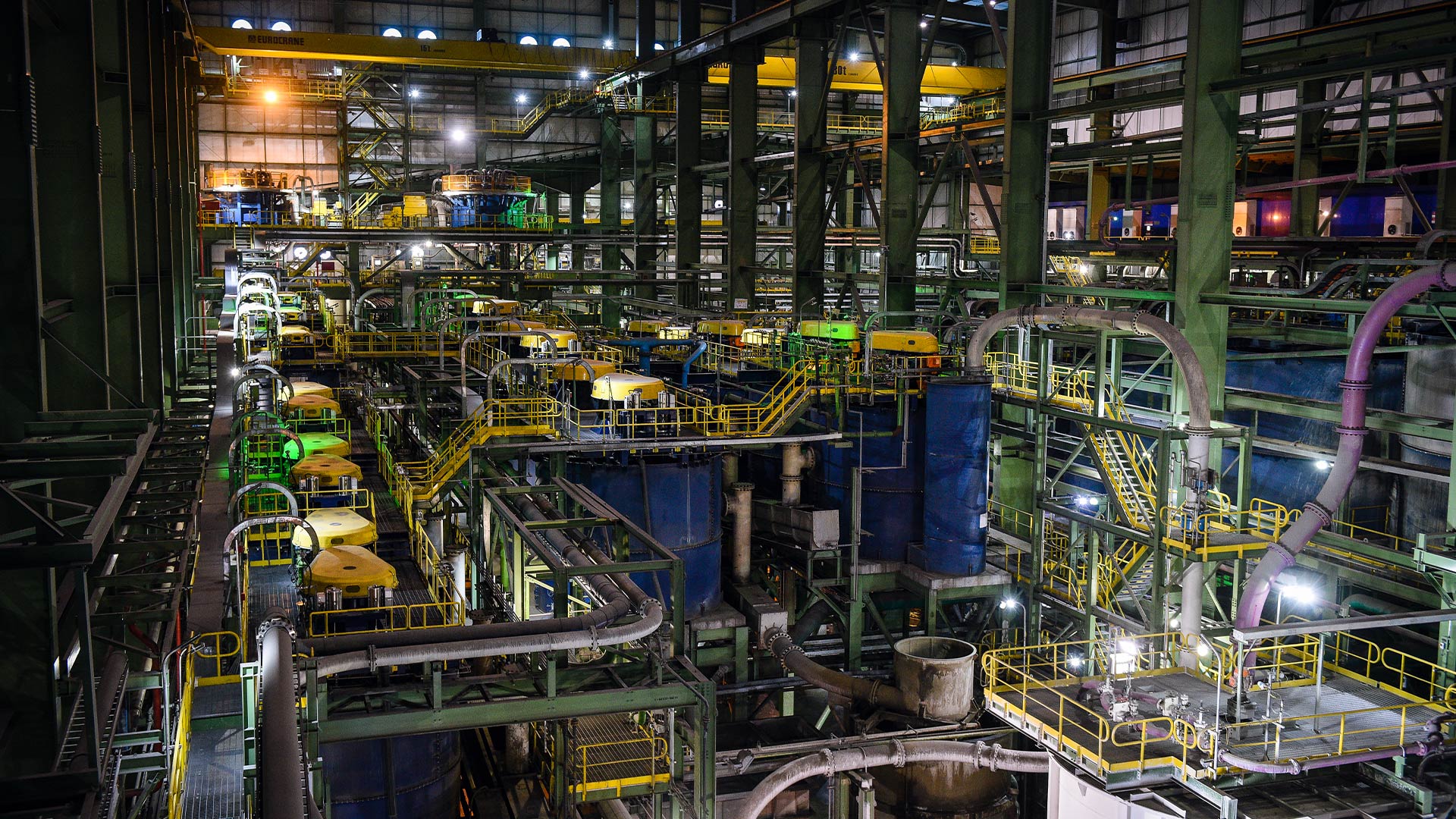 In the foreground us a mini truck transporting tools. In the background there are fields with trees and electricity pylons.